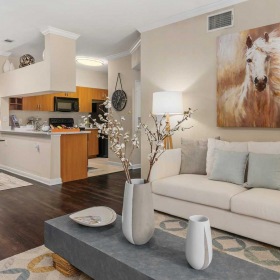 Find your perfect fit at Grandea Bellfort a living room with a couch and a table