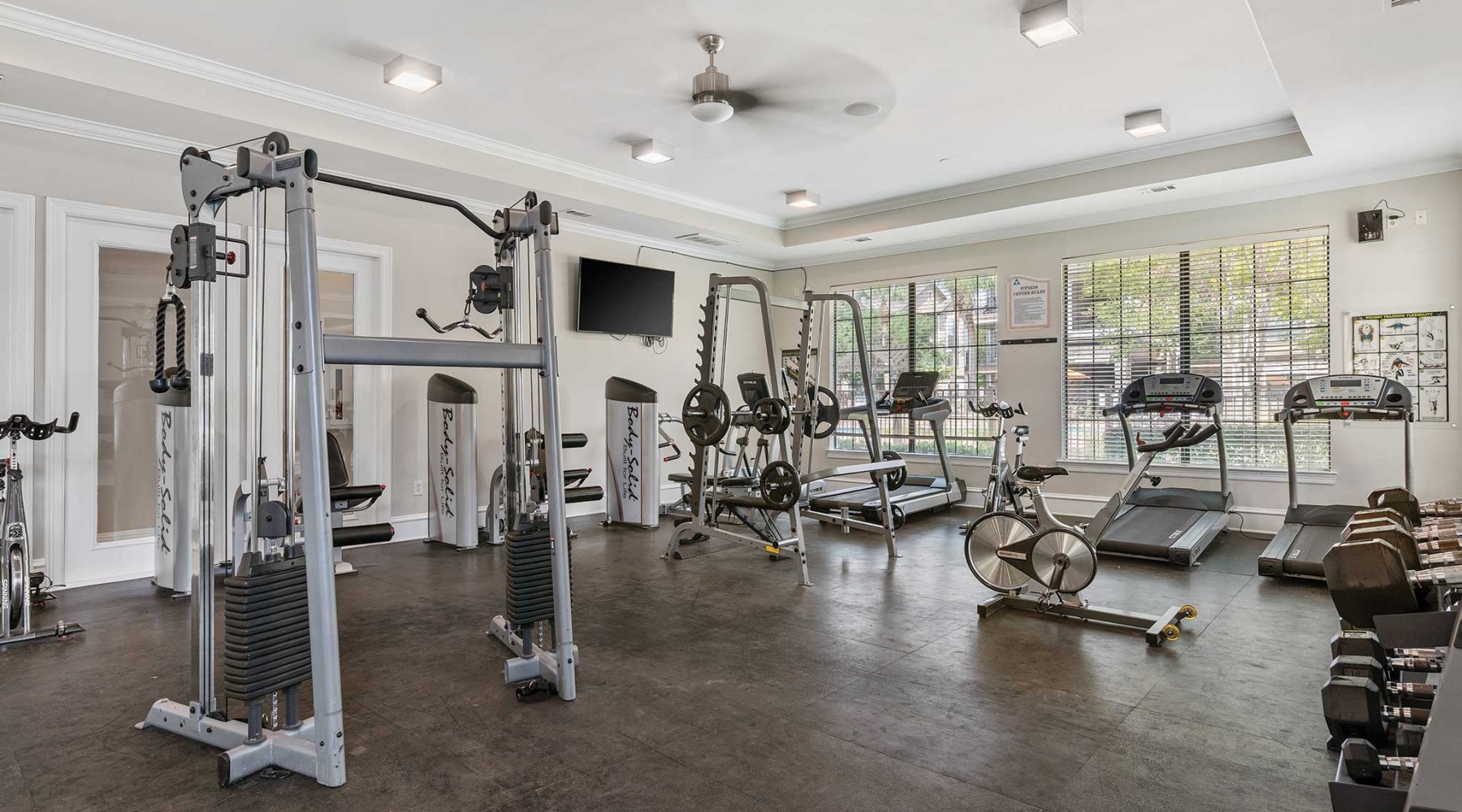 A Haven at Your Fingertips fitness room with equipment and on wood-style flooring